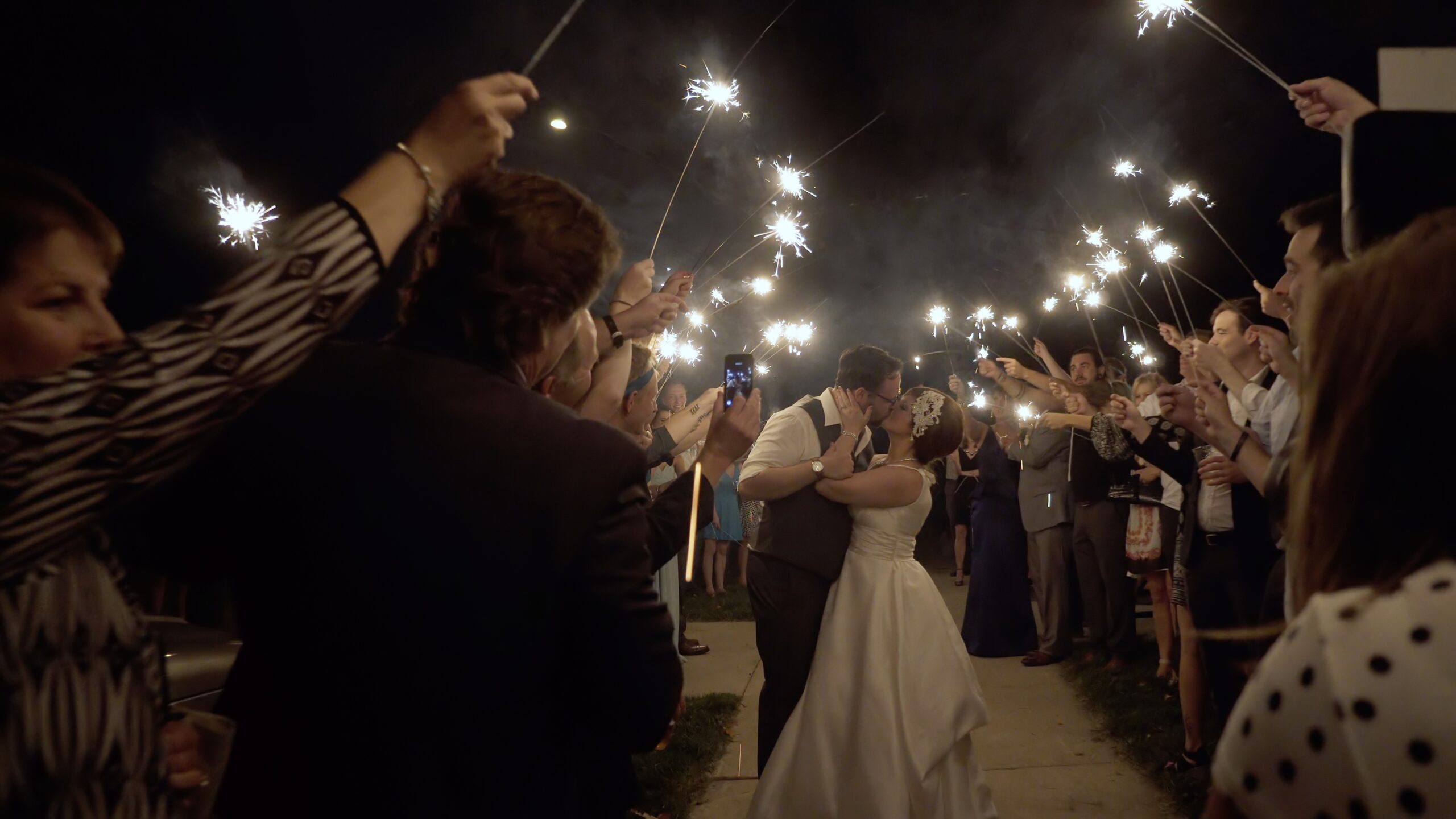 Mankato Old Main Village Wedding Couple Kissing During Sparkler Exit