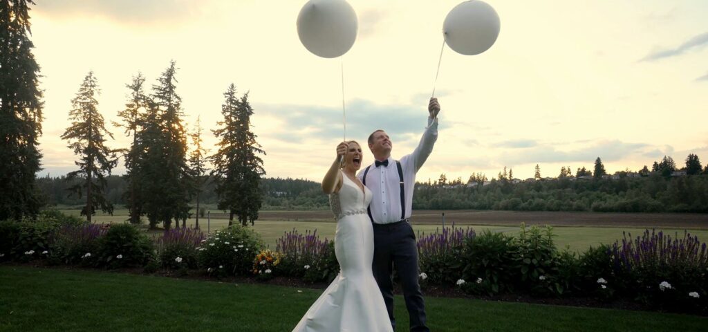 The Kelley Farm Wedding Bride and Groom with "Just Married" balloons in Garden. 