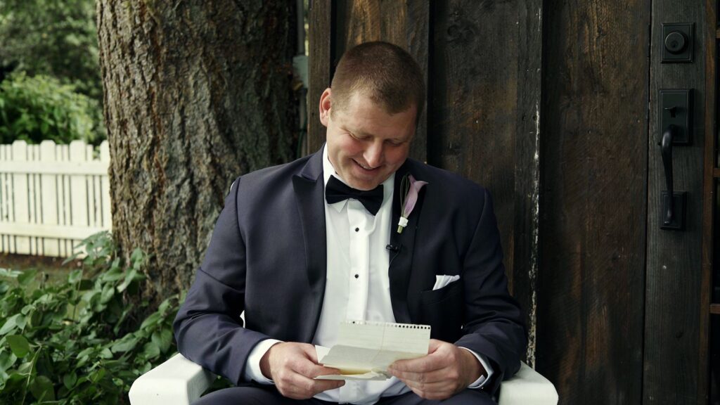 The Kelley Farm Wedding Groom reads letter from bride.