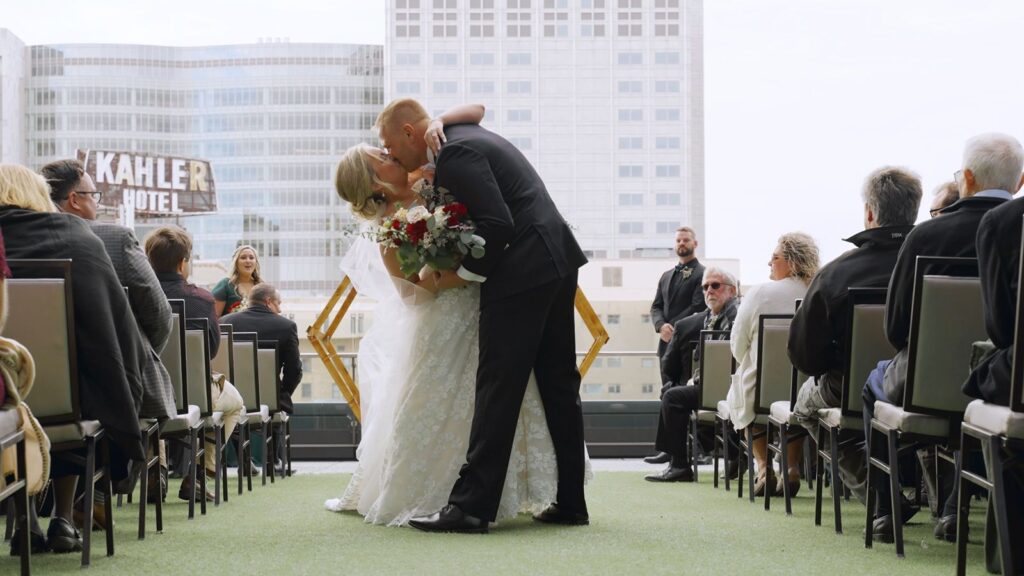 J Powers At The Hilton Wedding Bride and Groom exit ceremony with Rochester Skyline behind them.
