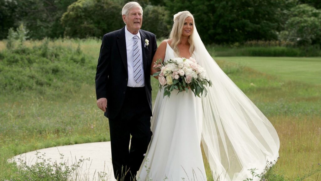 Bride walks down the aisle with her father at Bavaria Downs Wedding Videography