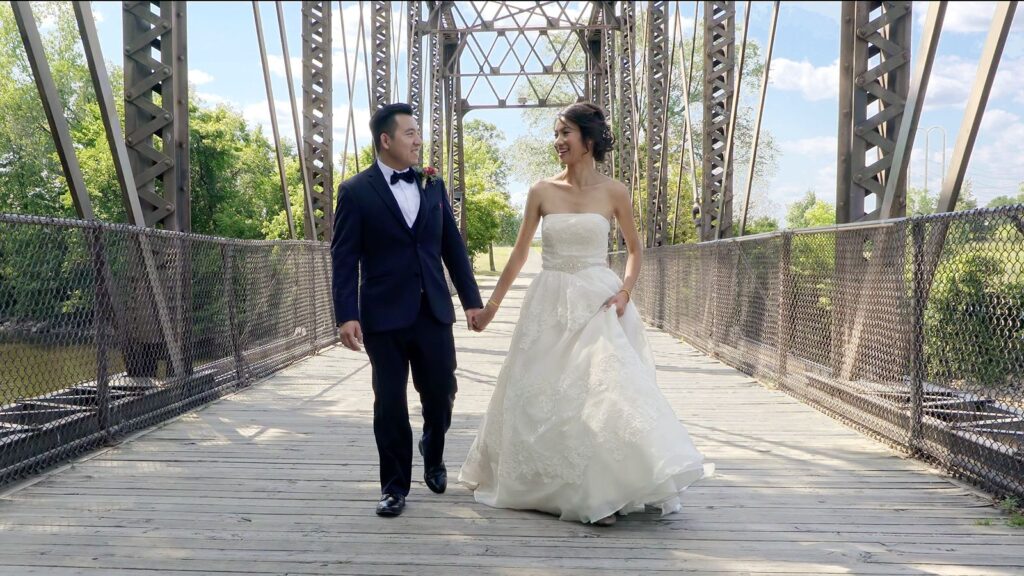 Vietnamese Wedding Bride and Groom walk on bridge at Boom Island Park