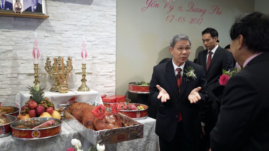 Vietnamese Weding Tea Ceremony Bride and Groom's Families persent roasted pig and other gifts.