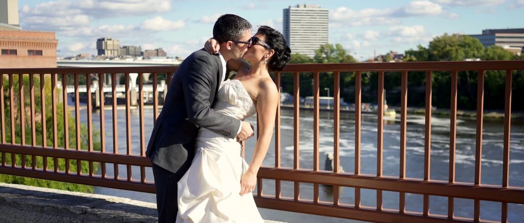 Minneapolis Radisson Blu Wedding Bride and Groom Kiss on Stone Arch Bridge