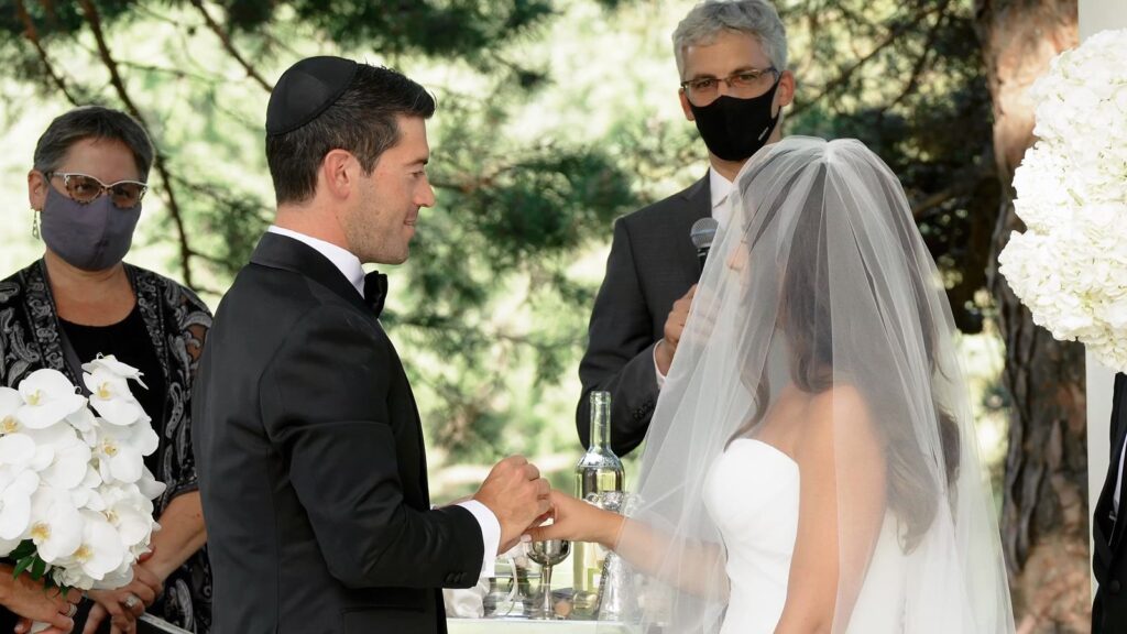 Outdoor Oak Ridge Country Club wedding ceremony under a Chuppah surrounded by trees and family