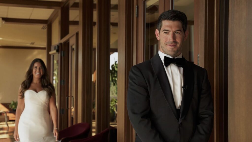 Bride and groom share a first look inside the Oak Ridge Country Club clubhouse before their ceremony