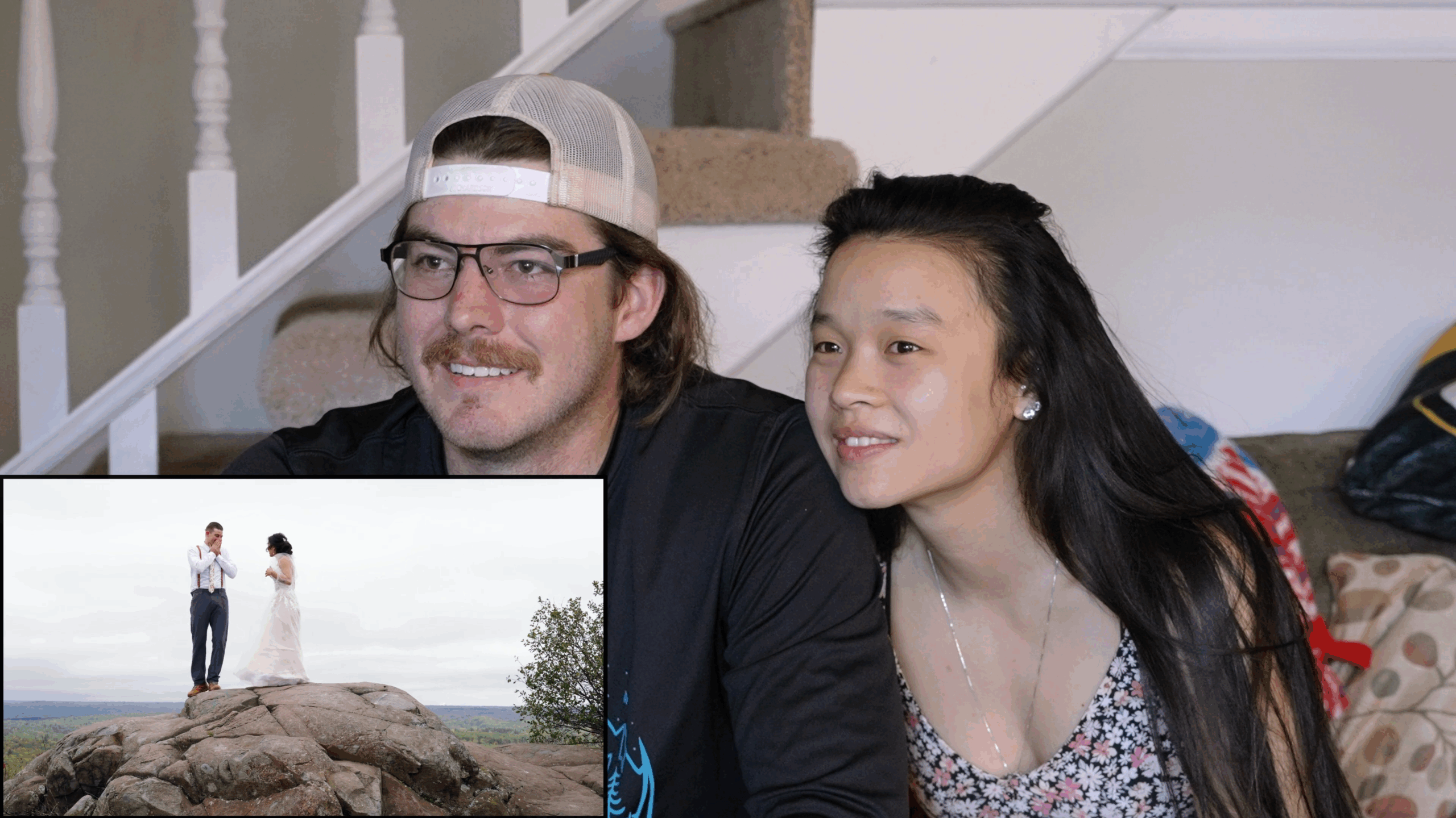Couple reacting emotionally to their Duluth elopement wedding video at their Airbnb