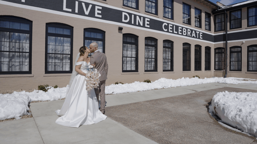 Is The Confluence Hotel a good wedding venue? Bride and Groom  in courtyard for photos with snow on the ground. 