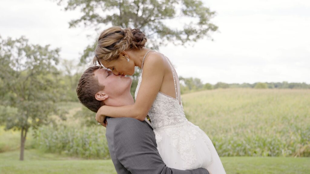 Bride and groom watching their wedding video for the first time during their backyard wedding in Webster Minnesota